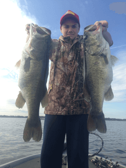 Kid with two giant Orlando Florida Largemouth Bass